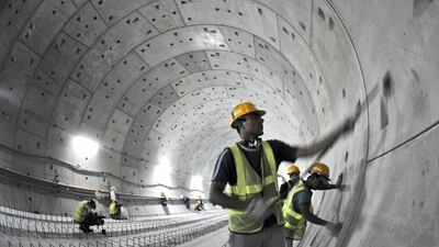 Workers put the finishing touches to the tunnel near Union metro station in May 28, 2008. According to the book, Sheikh Mohammed was warned Dubai would never embrace public transport. But it took thousands of cars off the roads and about 650,000 people now use the metro each day. Jumana El Heloueh / Reuters