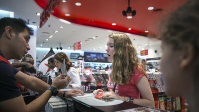 Petra New, centre, 14, reacts as she is about to receive her ticket to see One Direction in Dubai next year. Silvia Razgova / The National
