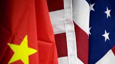 Flags of the US and China are displayed at American International Chamber of Commerce booth during China International Fair for Trade in Services in Beijing. REUTERS