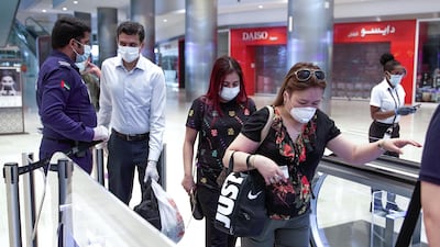 Employees at Yas Mall in Abu Dhabi. Victor Besa / The National