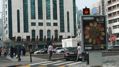 An advertisement board at the junction of Fatima bint Mubarak Street and Zayed the First (Electra) Street, blocks the view of drivers as they turn right toward a pedestrian crossing. Ravindranath K / The National