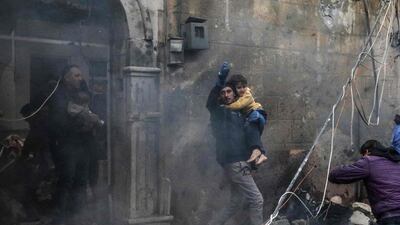 Civilians carry victims at the scene of an explosion in Azaz, northern Syria, on January 31, 2021. The town is in a rural, rebel-controlled part of Aleppo governorate. AFP