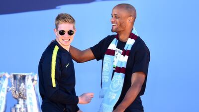 Kevin De Bruyne and Vincent Kompany of Manchester City celebrate on stage. Getty Images