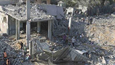 Palestinians survey a house which police said was destroyed in an Israeli air strike in Khan Younis in the southern Gaza Strip on Tuesday. Israel launched an offensive against Islamist Hamas in the Gaza Strip on Tuesday, bombing some 50 targets, including homes, in a campaign meant to end Palestinian rocket fire into the Jewish state. Ibraheem Abu Mustafa / Reuters