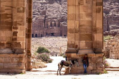 A Bedouin stands in the shade with his donkey at the reopened Petra archeological site, in Petra, some 280 km south of Amman, Jordan, 20 June 2020. EPA photo