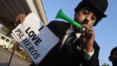 A cricket fan, dressed up as Charlie Chaplin, at the National Stadium in Karachi. AFP
