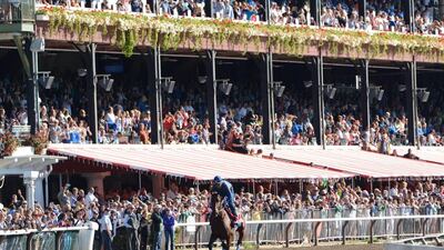 Fans watch Triple Crown winner American Pharaoh warm up at Saratoga Race Course on Friday for Saturday's Travers Stakes. Patrick Dodson /The Daily Gazette via AP