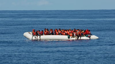An aid group said gunmen on Libya-flagged speedboats threatened the crew of its rescue ship Alan Kurdi. AP