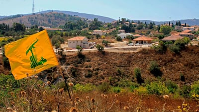 A Hezbollah flag flutters in the Khiyam plain on the Lebanese side of the border with Israel. Israel and Hezbollah exchanged fire on Sunday along the Lebanese border after a week of rising tensions, sparking fears of an escalation and prompting concern from world powers. AFP