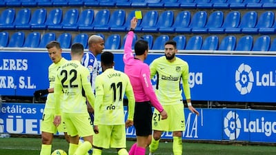 Atletico Madrid's Yannick Carrasco is shown a yellow card. Reuters