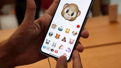 A man tries out the Animoji feature on the iPhone X during its launch at the Apple store in Singapore. Edgar Su / Reuters