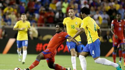 Haiti's Jeff Louis, center, moves the ball between Brazil's Renato Augusto (18) and Gil (4) during the second half of a Copa America group B soccer match Wednesday, June 8, 2016, in Orlando, Fla. Brazil won 7-1. (AP Photo/John Raoux)