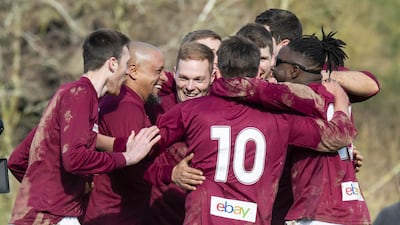 Roberto Carlos celebrates with Bull in the Barne United players after scoring a penalty for the team. PA