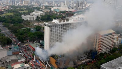 Firemen battle a fire that engulfs the Manila Pavilion Hotel and Casino Sunday, on March 18, 2018 in Manila, Philippines. Bullit Marquez / AP Photo