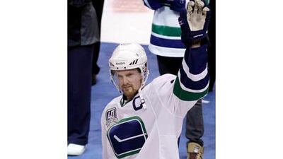 Vancouver Canucks center Henrik Sedin salutes the crowd after receiving his captain's jersey.