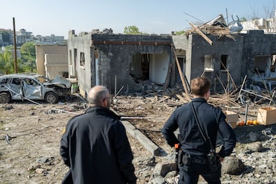Civilians and police stand outside a home destroyed by an Iranian missile strike in Zarzir, Israel. Getty Images