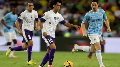 Omar Abdulrahman, centre, of Al Ain moves past Samir Nasri of Manchester City during their friendly at the Hazza bin Zayed Stadium in Al Ain on May 15, 2014. Satish Kumar / The National