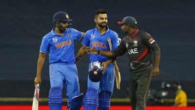 Shortly after the UAE’s Andri Berenger, right, offered congratulations to India’s victorious batsmen, Virat Kohli, centre, showed off his football skills at the Waca. David Gray / Reuters