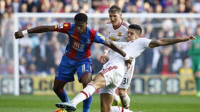 Crystal Palace's Wilfried Zaha in action with Manchester United's Marcos Rojo, right. Darren Staples / Reuters