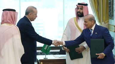 Saudi Crown Prince Mohammed bin Salman watches Turkish President Recep Tayyip Erdogan shake hands with Pakistan's Prime Minister, Shehbaz Sharif, after they signed the agreement in Makkah. Reuters