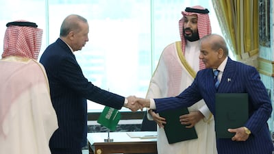 Saudi Crown Prince Mohammed bin Salman watches Turkish President Recep Tayyip Erdogan shake hands with Pakistan's Prime Minister, Shehbaz Sharif, after they signed the agreement in Makkah. Reuters