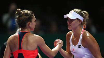 Angelique Kerber, right, greets Simona Halep at the net after her victory in their WTA Finals match. Julian Finney / Getty Images