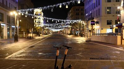 Two scooters are seen parked at the deserted Canebiere street in Marseille, southern France, moments after the 6pm curfew started, instead of 8pm, in the Bouches-du-Rhone departement. AFP
