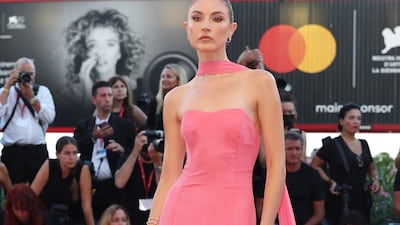Jacquelyn Jablonski, in a pink strapless dress with neck tie, attends 'The Son' red carpet. Getty