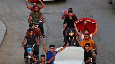 Youths celebrate in Akcakale, Sanliurfa province, southeastern Turkey, after the state-run Anadolu news agency reported the northern Syrian town of Tal Abyad had fallen to a Turkish military offensive. AP Photo