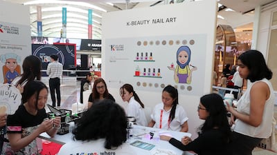 People visit the nail art stand