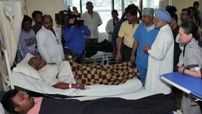 India's prime minister Manmohan Singh (second from right) and Sonia Gandhi (right), chief of India's ruling Congress party, meet with victims injured in an ambush at a hospital in the eastern Indian city of Raipur.