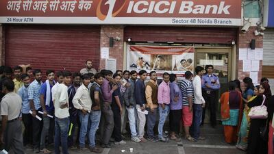 Indians stand in a queue to deposit and exchange discontinued currency notes, outside a bank on the outskirts of New Delhi, India on November 13, 2016. Altaf Qadri/AP Photo