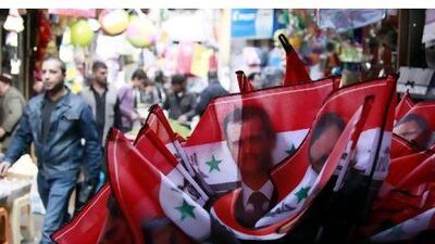 Syrian flags bearing the photo of President Bashar al Assad on sale in Damascus.