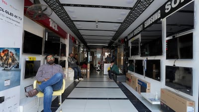 Staff at an electronic goods shop in Pakistan's commercial hub Karachi wait for power to be restored. Much of the country was left without electricity. AP