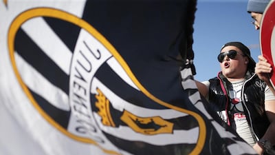 A Juventus supporter celebrates after the football club won the 'scudetto' Serie A title on Sunday. Marco Bertorello / AFP / May 4, 2014