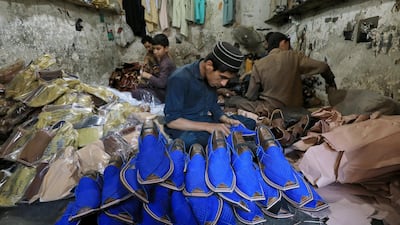 People are seen at a workshop in Peshawar, Pakistan. Reuters