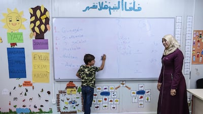Syrian children who lost their parents in the Russia-Ukraine war attend a class for orphans at the refugee camp. Getty Images