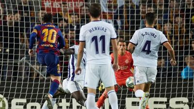 Leo Messi shoots to score the fourth goal during a Spanish La Liga match between Barcelona and Real Valladolid. EPA/ALEJANDRO GARCIA