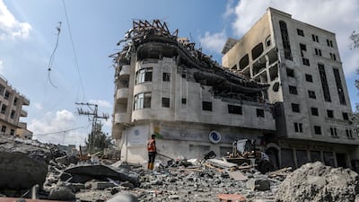 Palestinians inspect a destroyed building following Israeli air strikes in Al Ramal neighbourhood in Gaza city. EPA