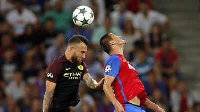 Manchester City's Nicolas Otamendi, left, and Steaua's Bojan Golubovic, right. (EPA)