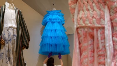 Employee Grace Morgan adjusts a design by Molly Goddard, made famous by Rihanna. Reuters