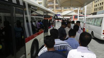 Passengers at Al Ghubaiba bus station in Dubai queue for a bus that will take them to Abu Dhabi. Jeffrey E Biteng / The National