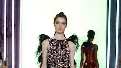Black dress hand-embroidered with sequins and shiny beads, featuring ruffles of velvet lurex and devoré black feathers