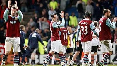 Burnley players applaud their loyal fans after a 4-0 loss to Liverpool in April sealed their relegation to the Championship.