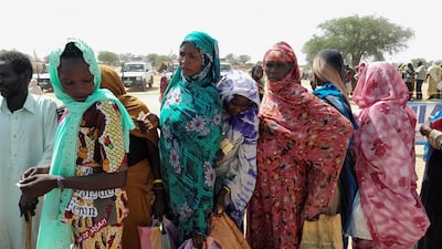 Sudanese refugees who have fled the violence in their country gather to receive food from the UN World Food Programme near the border between Sudan and Chad. Reuters.