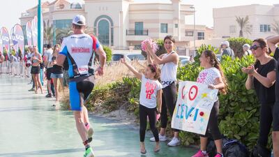 Spectators cheer Ironman competitors at Jumeirah beach. Leslie Pableo for The National