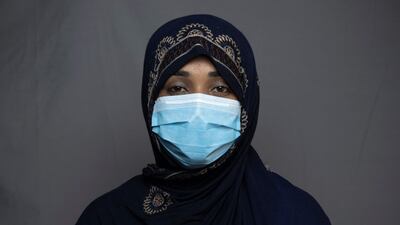 Seamstress Rozia Khpalwak, 23, poses for a portrait in Kandahar.