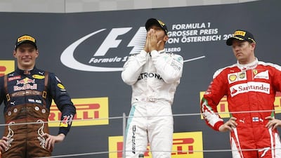 Mercedes driver Lewis Hamilton flanked by Red Bull’s Max Verstappen and Ferrari’s Kimi Raikkonen pose after the Formula One Austrian Grand Prix. Dominic Ebenbichler / Reuters