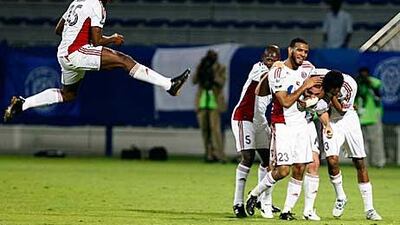 Jader Volnei is congratulated by his Al Jazira teammates after scoring their opener in their 2-1 win at Al Nasr last night.