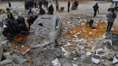People collect scattered oranges amidst rubble after an airstrike on a market in the rebel-held city of Maarrat Misrin in Syria's Idlib province on January 14, 2017. Ammar Abdullah/Reuters